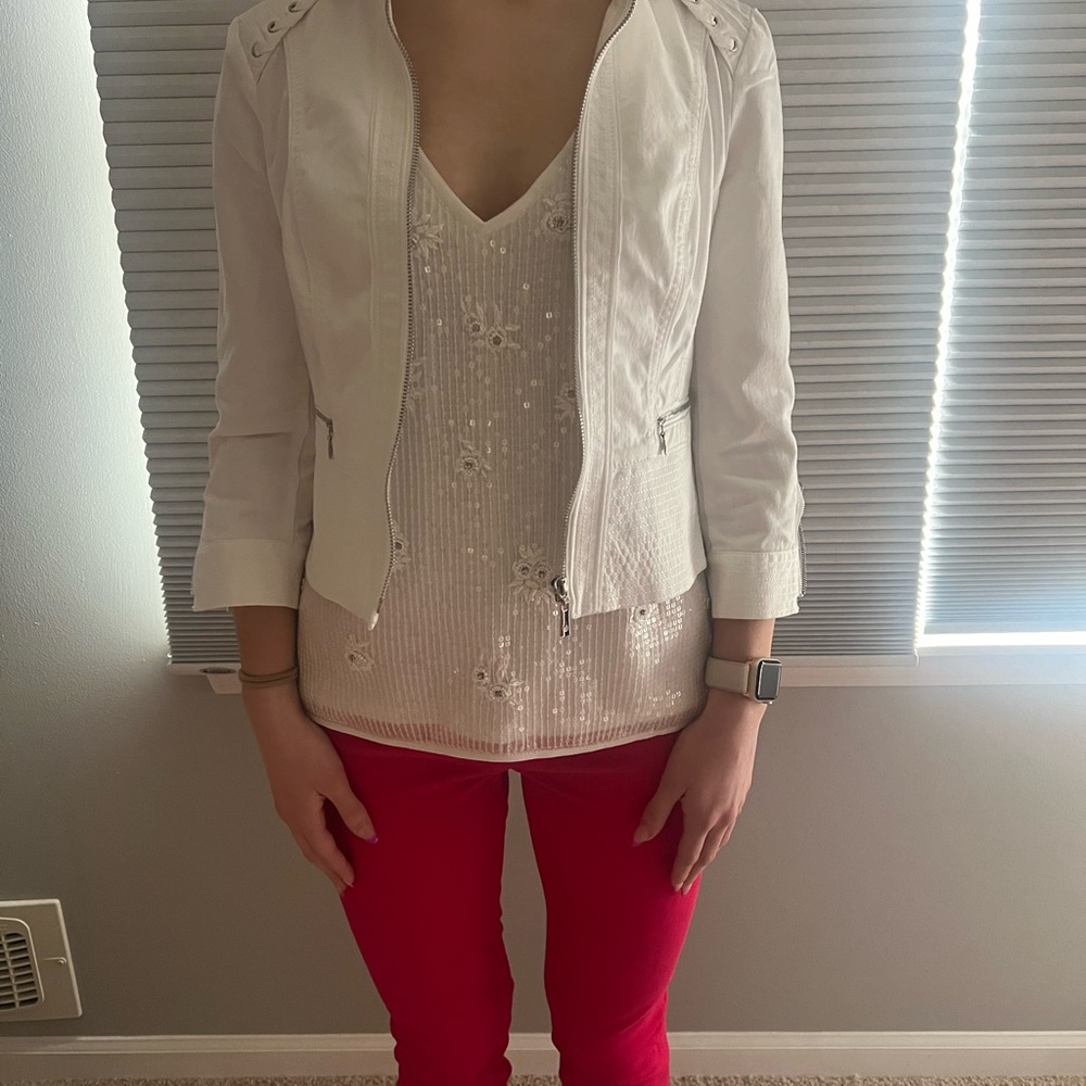 White jean jacket with laced and stitched accents on back and front